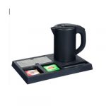 Conjunto de chaleira elétrica com base retangular preta para hotel, apresentando divisórias para saquetas de chá e grelha de drenagem em aço inoxidável."